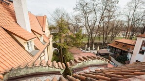 Un barrio residencial con tejados de tejas rojas, una mezcla de arquitectura tradicional y moderna, y vistas a un parque con árboles desnudados.