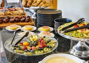 A buffet with various food items including fruits, pastries, and breakfast dishes. - Calvinia Hotel by Country Hotels (Hantam)