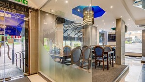 A hotel lobby with a lounge area, glass doors, and a modern interior design. - London Star Hotel (London)