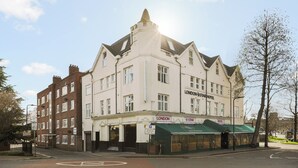 A corner building with a sign for "London Star Hotel" and a green awning. - London Star Hotel (London)