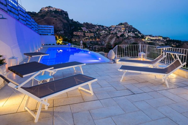 Seasonal outdoor pool, pool umbrellas, pool loungers