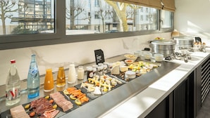 A buffet with various meats, cheeses, and fruits. - Best Western Plus Central Park Hotel & Spa (La Rochelle)
