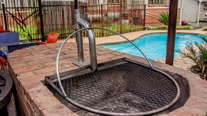 A pool with a metal grate and a hose. - Thembelihle Guest House (Pietermaritzburg)