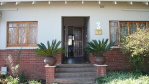 A two-story house with a tiled roof, a brick facade, and a number '3' sign above the entrance. - Thembelihle Guest House (Pietermaritzburg)