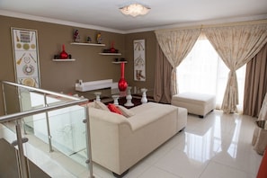 Deluxe Suite, 1 Bedroom | Living area | LCD TV