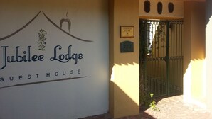 A guesthouse with a sign reading "Jubilee Lodge" and a plaque indicating "300 Drive".