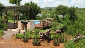 A pool area with a wooden deck, a hot tub, and a pergola. - Leselo La Bontshi Lodge (Groblersdal)