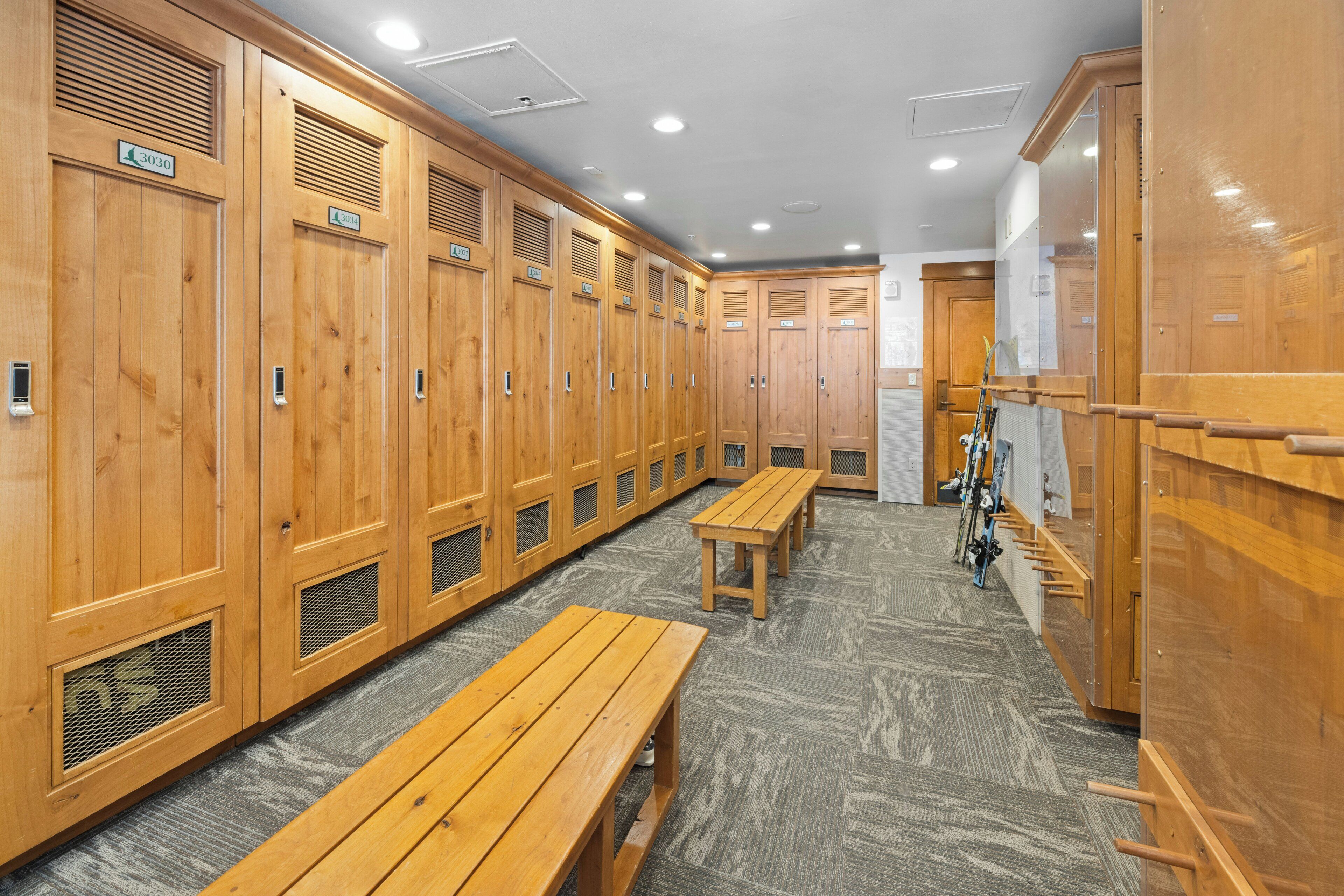 A locker room with wooden lockers, benches, and a bicycle rack.