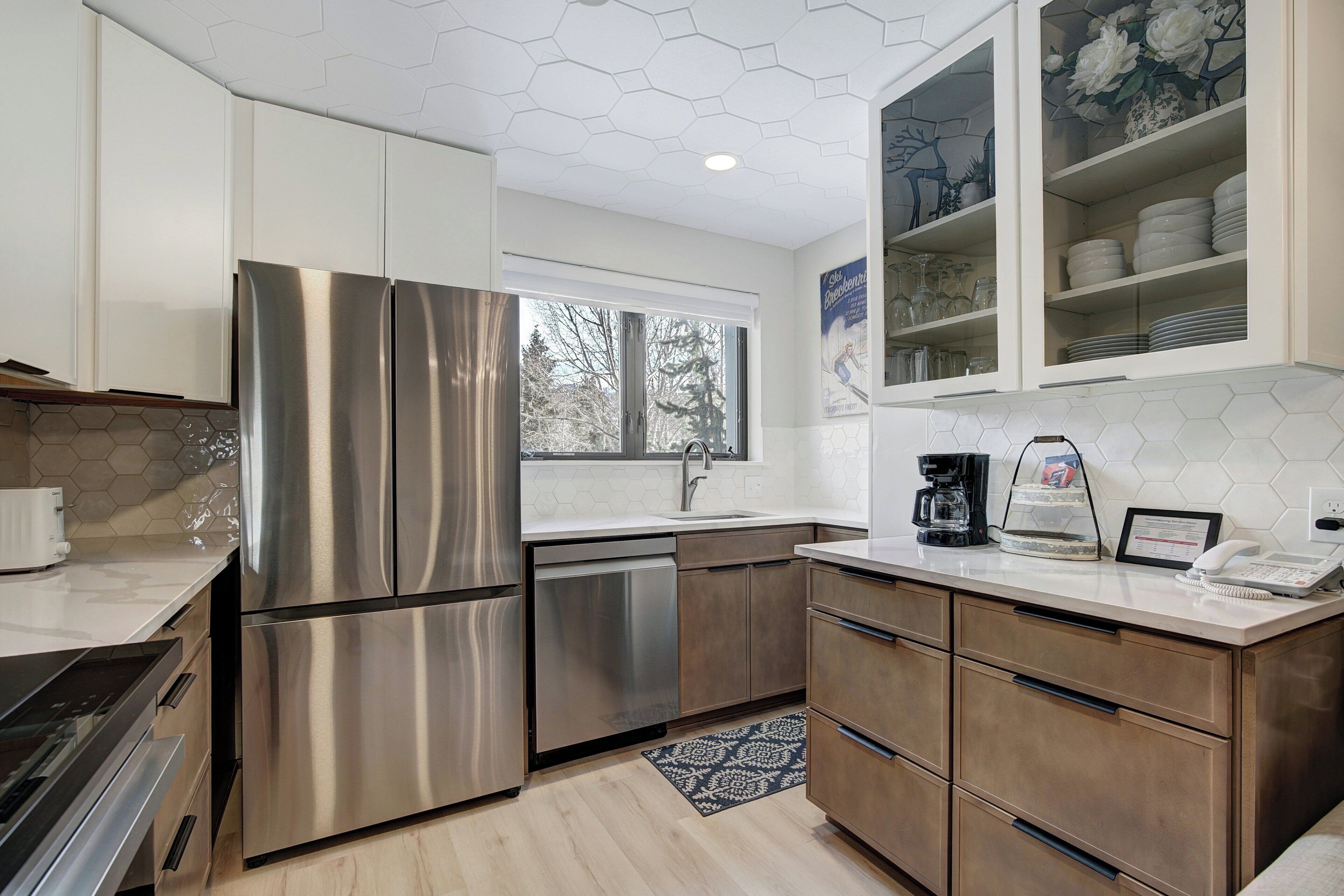 A modern kitchen with stainless steel appliances, a dishwasher, and a coffee maker.