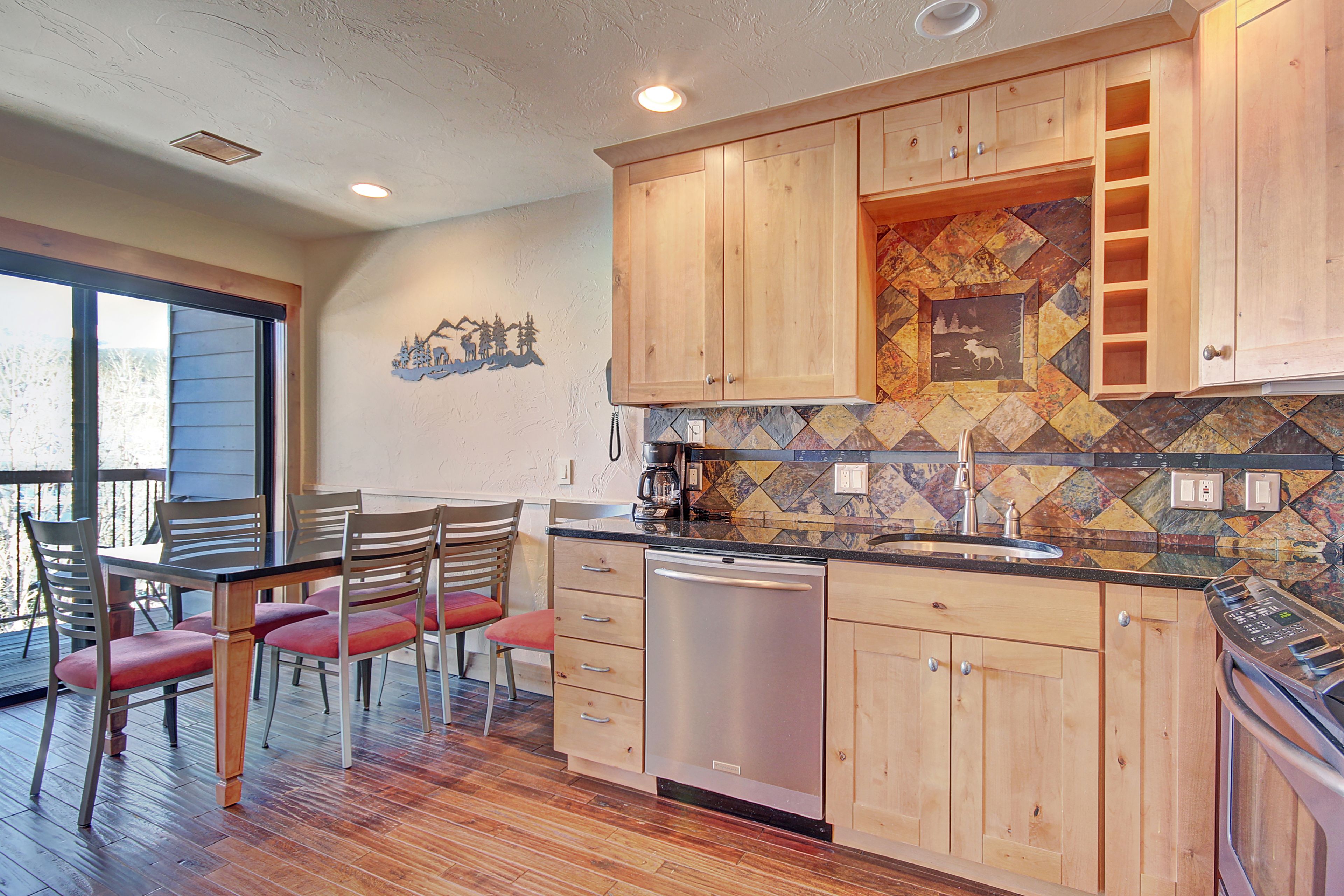 A kitchen with wooden cabinets, a dishwasher, and a tiled backsplash.