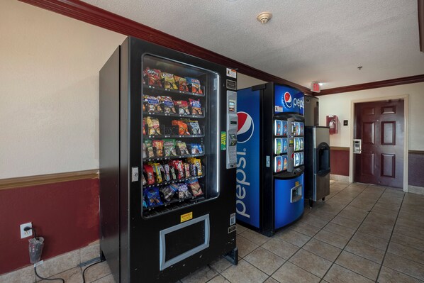 A vending machine area with snack options and a Pepsi refrigerator.