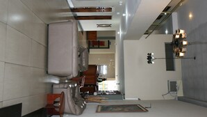 A modern hotel room with a large bed, a desk, and a chair. There is a painting on the wall and a window with curtains. - Hotel Olimpico Quevedo (Quevedo)