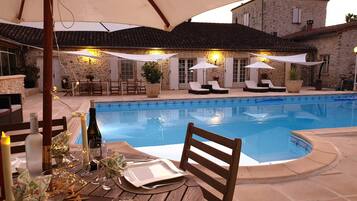 Outdoor pool, a heated pool, open open 24 hours, pool umbrellas