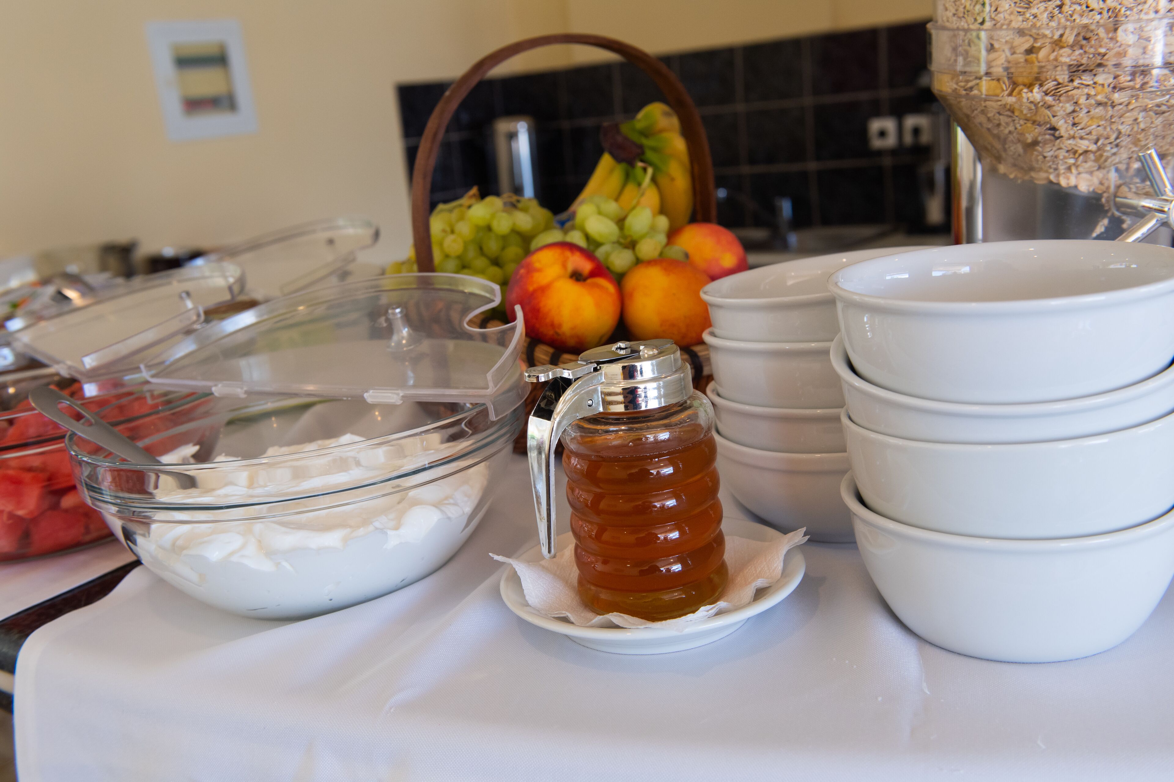 A buffet setup with various food items and containers.
