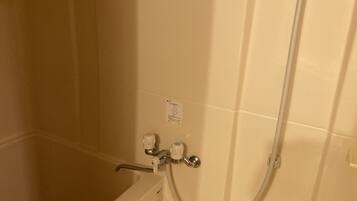 A bathroom with a bathtub, a shower, and a toilet.