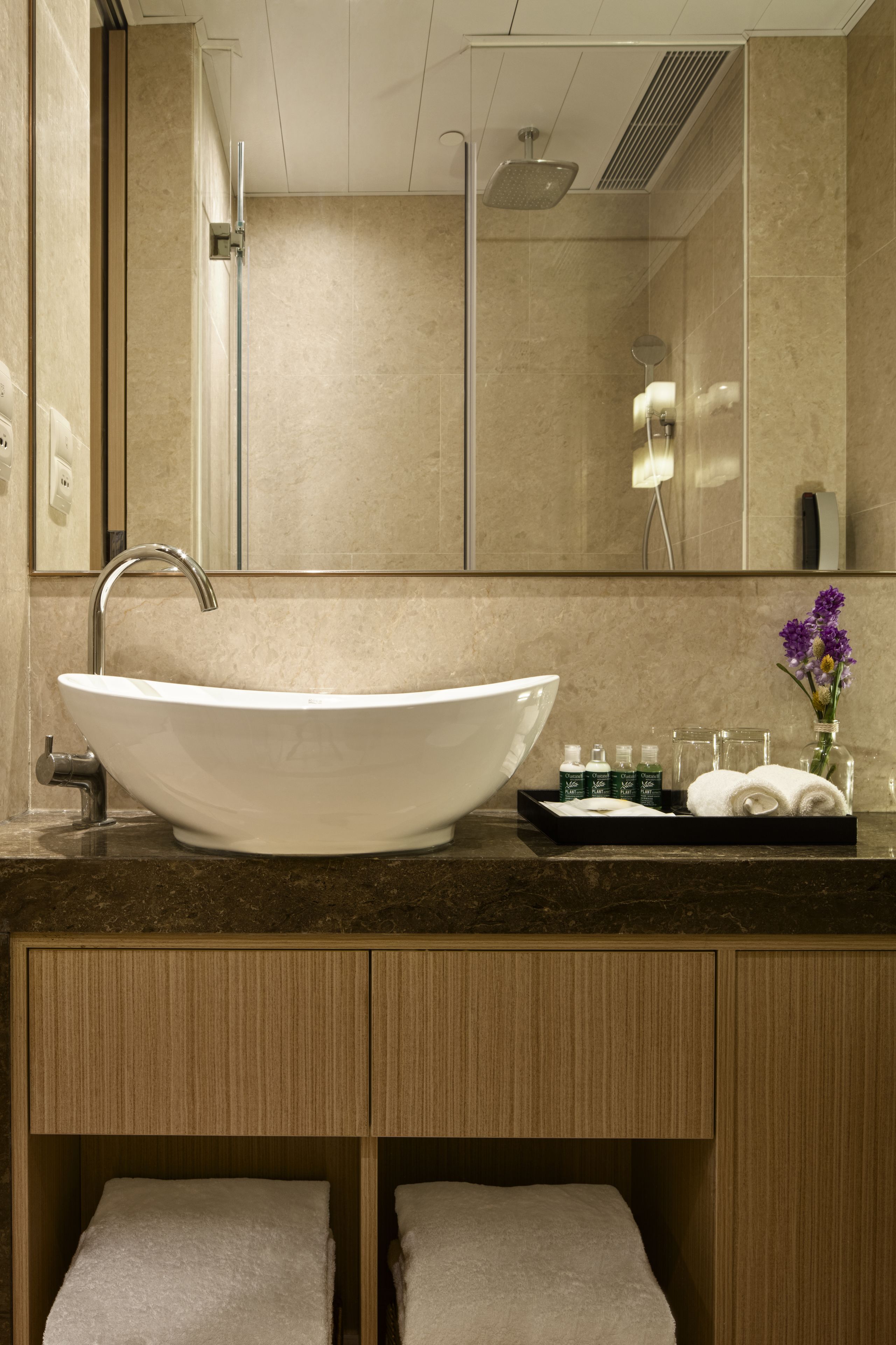 shower, hair dryer, slippers, towels