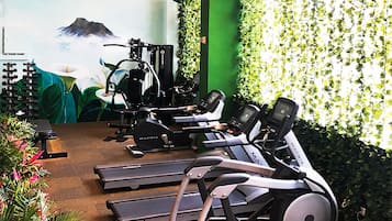 A gym with stationary bikes, treadmills, and exercise equipment.