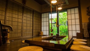 A traditional Japanese room with tatami flooring, a low wooden table, and shoji screens. - Yurari Rokumyo (Yufu)