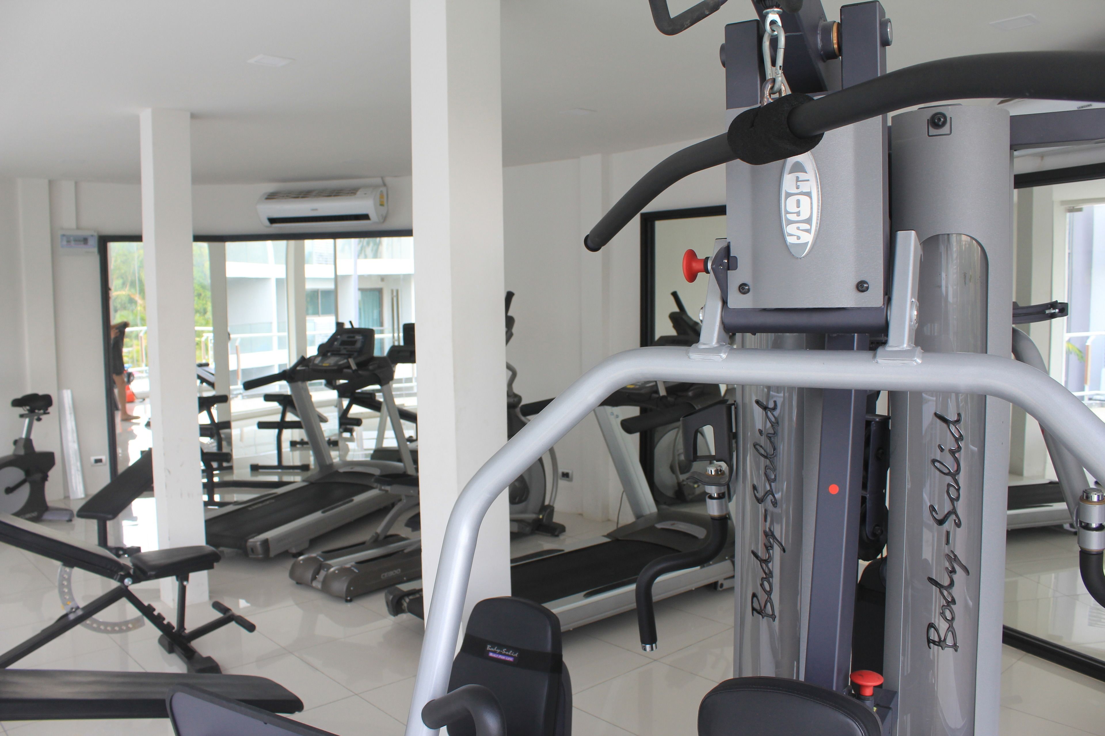 A gym with various exercise equipment including treadmills and weight machines.
