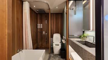 A modern bathroom with a wooden vanity, a shower, and a toilet.