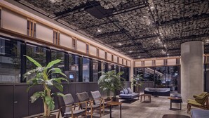 A spacious lobby with seating areas, large windows, and a unique ceiling design. - Sotetsu Hotels The Splaisir Seoul Myeongdong (Seoul)