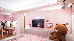 A room with a ball pit, a large teddy bear, a television, and a disco ball. - Sotetsu Hotels The Splaisir Seoul Myeongdong (Seoul)