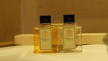 Two bottles of Euphoria Collection Baby & Nourish and Conditioning Shampoo on a white surface.