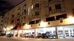 A multi-story parking garage with several cars parked inside. - B.P Grand Service Apartment (Chiang Mai)