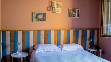 A bedroom with a wooden bed, two bedside tables, and a sloped ceiling.