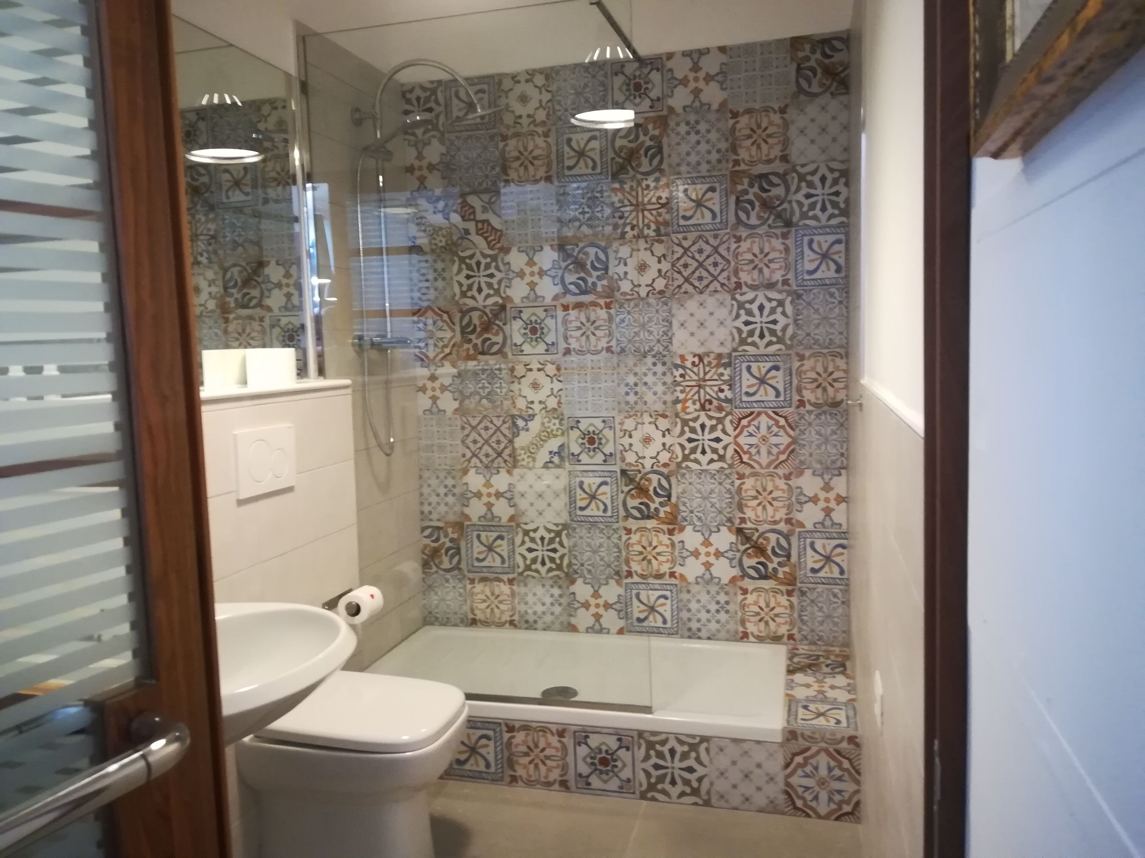 A bathroom with a shower, toilet, and sink.