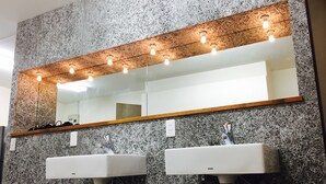 A bathroom with two sinks, a mirror, and a wooden shelf. - The Evergreen Hostel (Hiroshima)