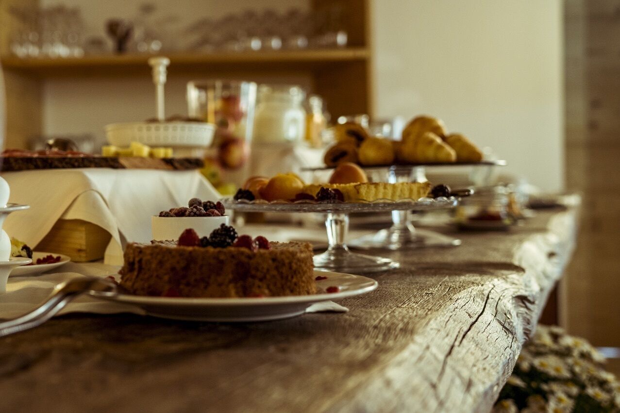 Una mesa de buffet con diversos postres y pasteles.