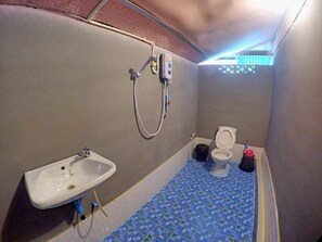 A small bathroom with a sink, toilet, and shower. - KK Hut (Pai)