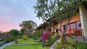 A house with a garden, a pathway, and a fence. - Segara Tegeh - Hostel (Tulamben)