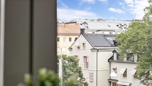 A view of a row of buildings with varying architectural styles, including a building with a sloped roof and another with a flat roof. - Hotell Kringelstaden (Sodertalje)