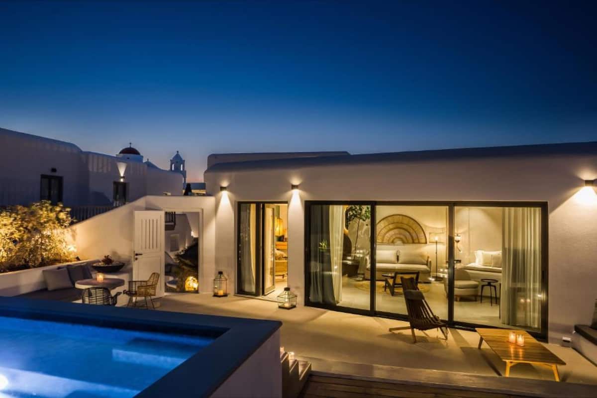 Relax by the pool in a serene outdoor space with a lounge chair and table.