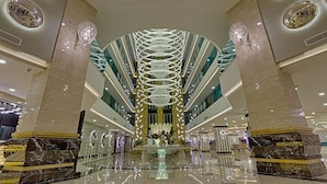 A spacious lobby with a central chandelier, marble columns, and a reflective floor. - Sensitive Premium Resort & Spa - All Inclusive (Serik)
