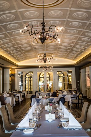 A formal dining room with a long table set for a meal, elegant chandeliers, and a decorative ceiling. - Sensitive Premium Resort & Spa - All Inclusive (Serik)