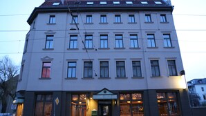Un edificio de varios pisos con un letrero que dice "BISTRO DE Saxe" en la entrada.