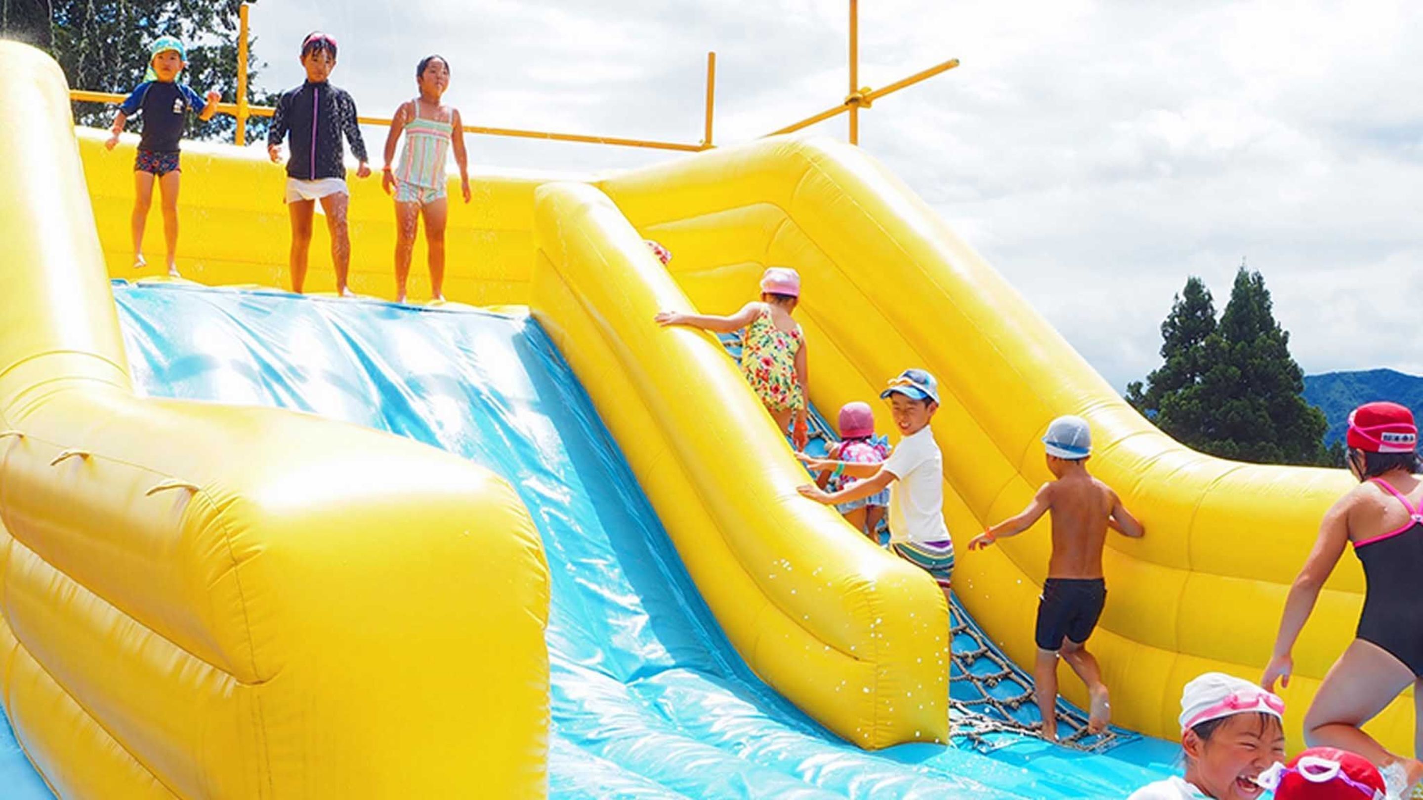 A water slide with inflatable sides and a blue water channel.