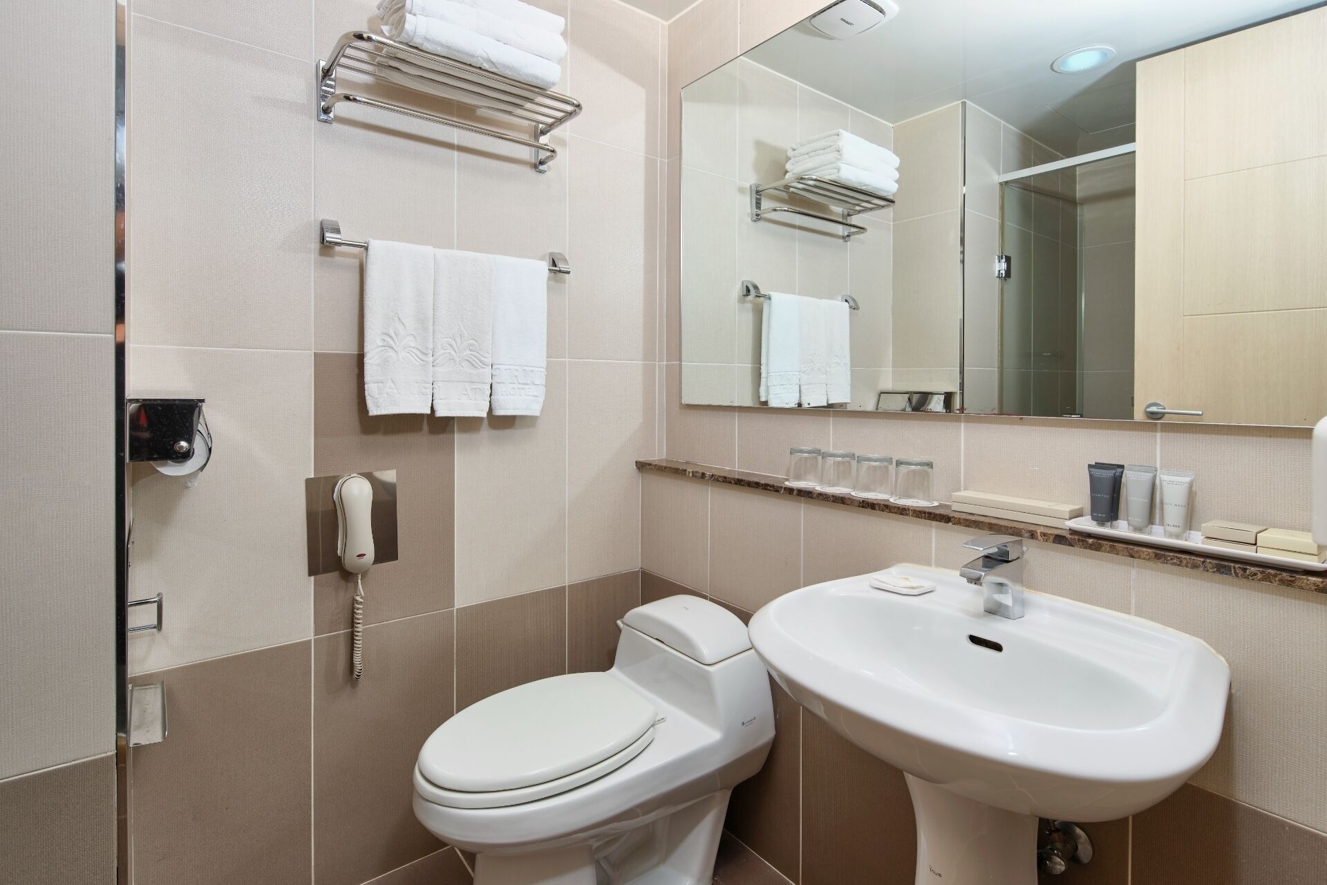 shower, hair dryer, slippers, towels