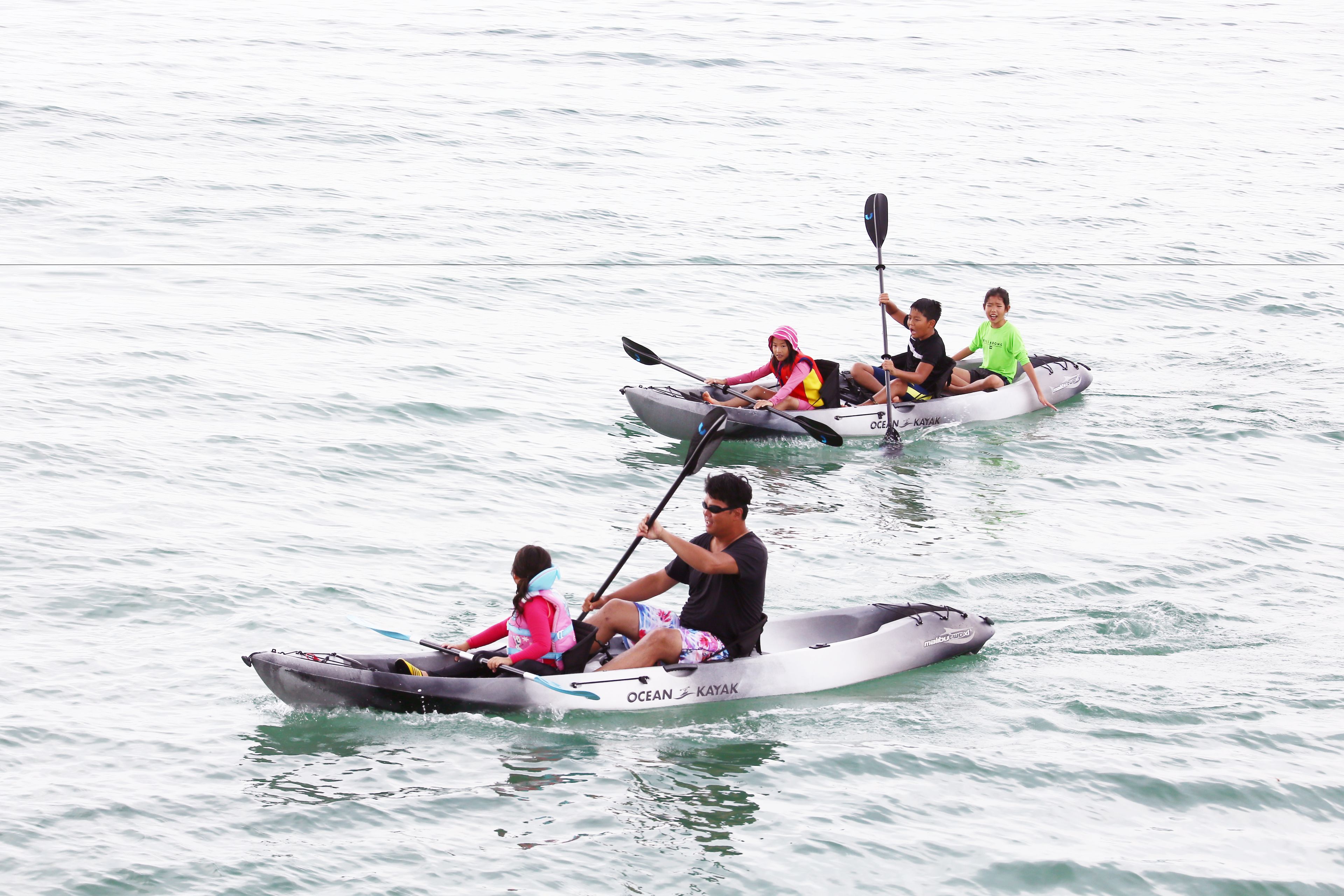 Two kayaks on calm water.
