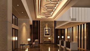A modern lobby with a polished floor, a reception desk, and a large framed artwork on the wall. - Geno Hotel (Shah Alam)