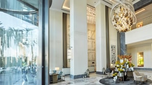 A spacious lobby with a marble floor, a large chandelier, and a reception desk. - Kempinski The Boulevard Dubai (Dubai)
