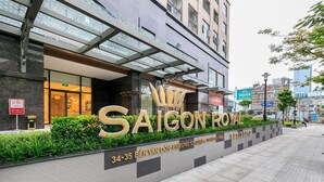 Entrada de un hotel con un gran letrero que dice "SAIGON ROYAL" y el número "34-35" indicando la dirección.