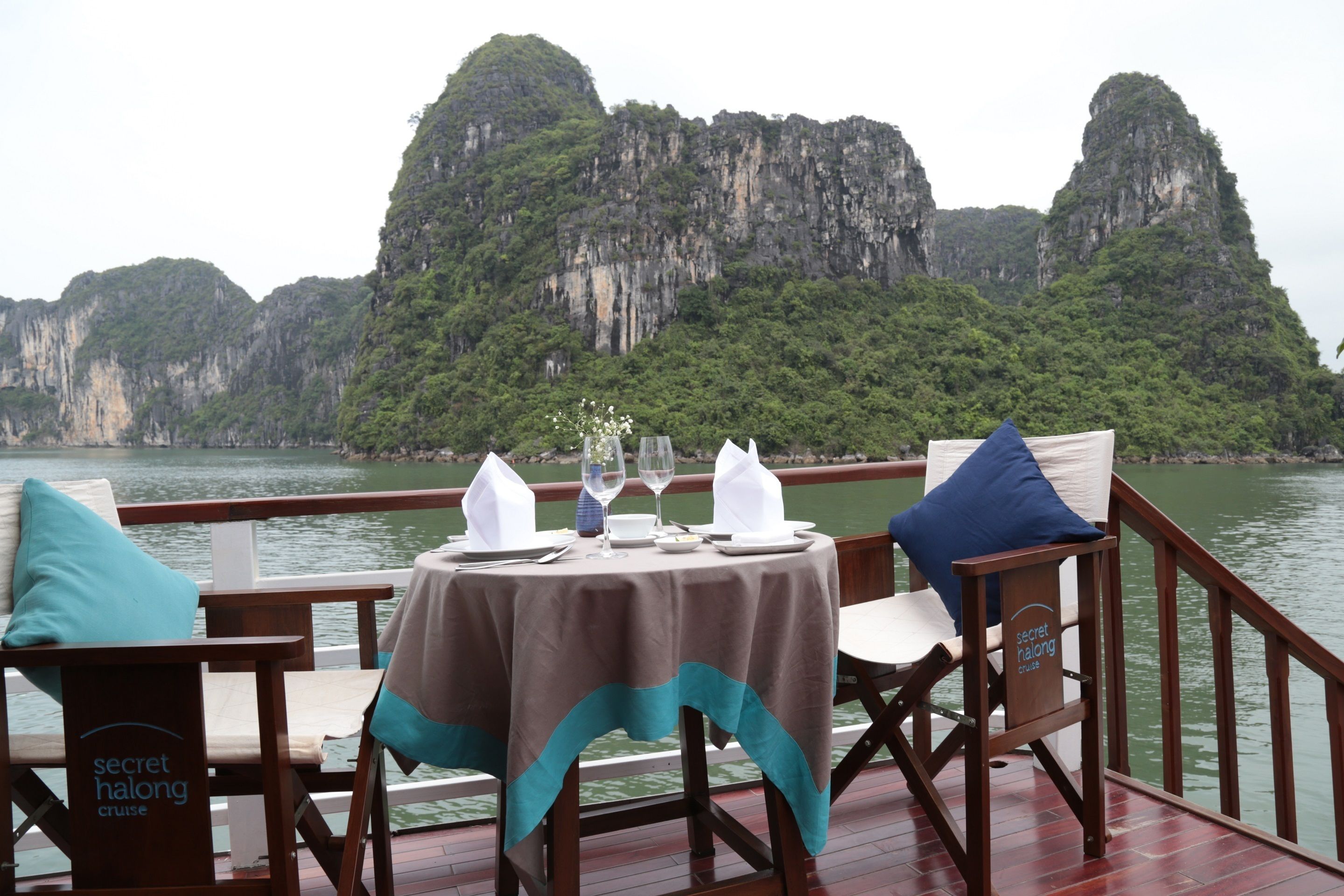 Mesa de comedor en una terraza con vista a acantilados de piedra caliza.