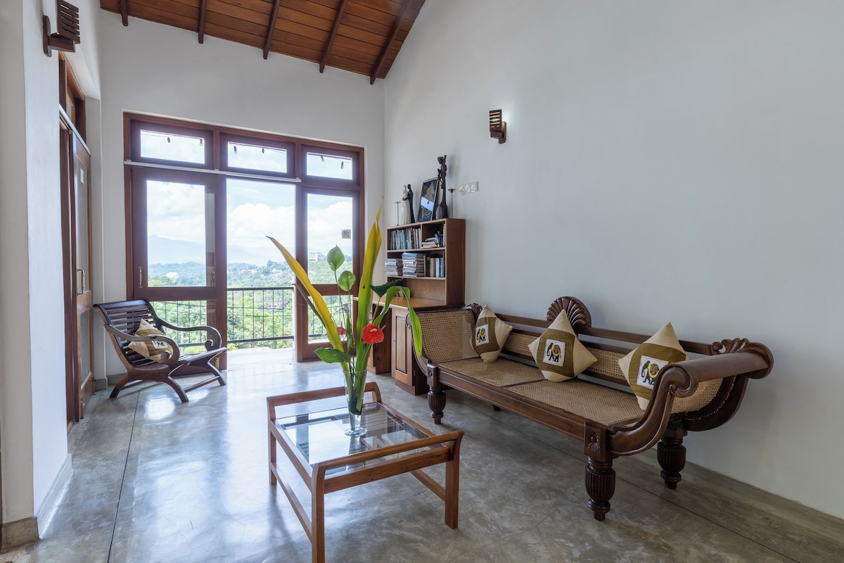 Two Bedroom Mountain View Family Apartment | Living area | Flat-screen TV, books