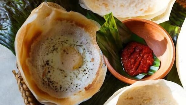 A traditional South Indian dish, possibly idli, served on banana leaves with a side of chutney. - Hanthana House (Kandy)