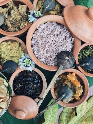 A variety of food items in clay pots, some with lids and spoons. - Hanthana House (Kandy)