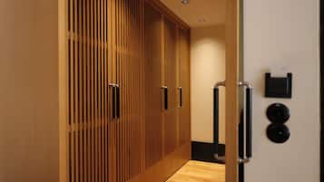 A hallway with wooden paneling and a wooden floor.